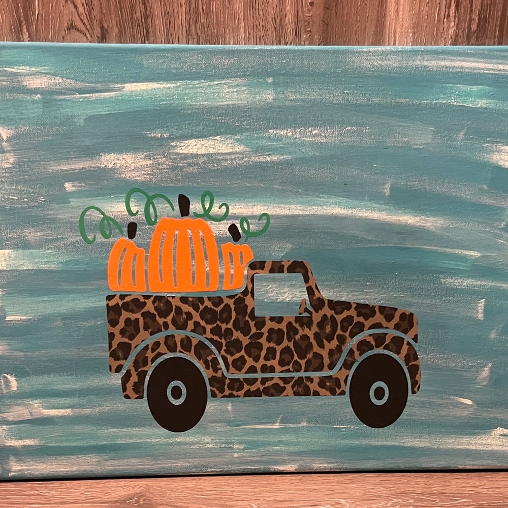 Cute leopard farm truck with pumpkins